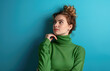 © Kien - Portrait of nice attractive lovely short hair woman wear green turtleneck sweater thinking holding chin looking up isolated on blue color background