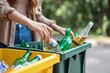 Woman recycling glass bottle
