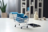 Fototapeta Uliczki - Smartphone displaying a shopping cart on table near laptop, online shopping activities concept. Various sale boxes and shopping bags Inside the cart, as e-commerce transactions and purchases.