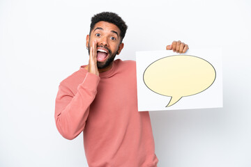 Wall Mural - Young Brazilian man isolated on white background holding a placard with speech bubble icon and shouting