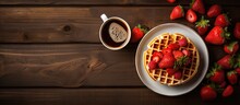 Plated Waffles Topped With Fresh Strawberries Served With A Side Of Coffee For A Delightful Morning Breakfast