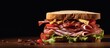 A detailed view of a sandwich filled with assorted meats and fresh vegetables placed on a rustic wooden table, highlighting succulent deli ham slices