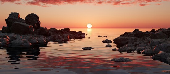 Aufkleber - A picturesque sunset over a calm body of water, beautifully reflecting the golden hues of the sun with scattered rocks emerging on the surface
