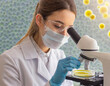 The scientist holds an open petri dish with colonies of bacteria under the lens of a microscope an increase in small microbes under a microscope. Creative Banner. Copyspace