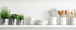 © Torrent - white kitchen utensils on a white shelf with plant on t 8102fbca-3d1a-4a42-82d2-3c4761e30fe3