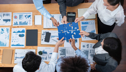 Wall Mural - Panorama top view diverse corporate officer worker collaborate in office connect puzzle piece as partnership and teamwork concept. Unity and synergy in business success with jigsaw puzzle. Concord