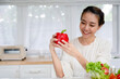 Young woman embraces joyful moments in kitchen.