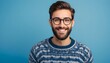 portrait of Young handsome man with beard wearing casual sweater and glasses over blue background happy face smiling looking at the camera. Positive person.