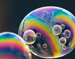 Colorful soap bubble patterns with a dark background