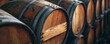 Dark brown wooden oak barrels in a cellar, with aerial abstractions and light amber and indigo colors.