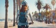 Rear view of a girl cyclist along the coast of a tourist city. Generative AI.