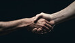 Close up two mana shaking hand on dark background