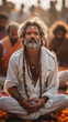 Happy Middle age indian yogi with white beard sitting on a river bank Ganges. AI Generative
