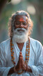 Happy Middle age indian yogi with white beard sitting on a river bank Ganges. AI Generative