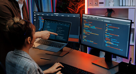 Wall Mural - serious of it developers discussing intelligent website development coder system running data online