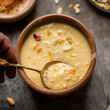 Rabdi, a rich and creamy Indian dessert made by reducing milk and sweetening it with sugar, flavored with cardamom and garnished with nuts