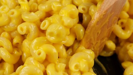 Wall Mural - Mixing pasta with cheese sauce, close up