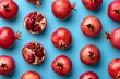 Top view of ripe and juicy pomegranate fruit on vibrant blue background for a fresh and colorful flat lay concept