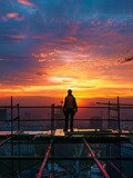 Fototapeta Paryż - Silhouette of a Construction Worker at Sunset