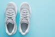 Top view of pair of modern sport shoes on blue background