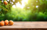 apricot fruit on wooden table on blurred nature citrus trees gar