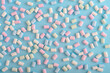 Colorful marshmallows pattern on blue background.