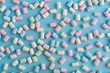 Colorful marshmallows pattern on blue background.