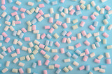 Fototapeta Koty - Colorful marshmallows pattern on blue background.