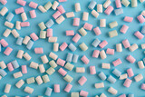Fototapeta Koty - Colorful marshmallows pattern on blue background.
