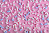Fototapeta Lawenda - Colorful marshmallows pattern on blue background.