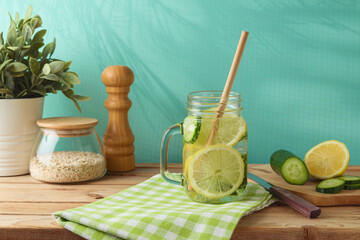 Wall Mural - Infused water with lemon and cucumber on wooden table. Detox, diet, healthy eating or  weight loss concept background