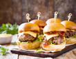 Beef sliders with cheese and served on a bun. 