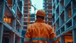 A construction worker wearing a helmet checks a building site. He ensures the building meets safety standards and is ready for the new occupants.
