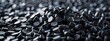 Close up 3D illustration of black plastic pellets a type of polymer resin