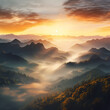 Sunrise over a mountain range with mist in the valley