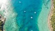 © Wirestock - Aerial view of several boats peacefully floating in the pristine ocean water.