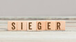 Word Sieger (German for winner) on wood cubes