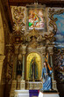 elaborate ornate church interior depicting religious scenes showing the alter and portico's