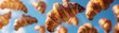 Random closeup of mini croissants, appearing to float, vibrant blue sky, photorealistic ,3DCG,high resulution