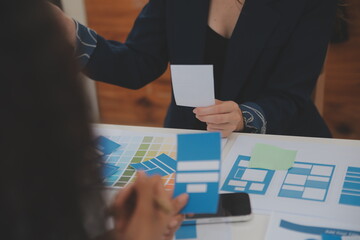 Close up ux developer and ui designer use augmented reality brainstorming about mobile app interface wireframe design on desk at modern office.Creative digital development agency