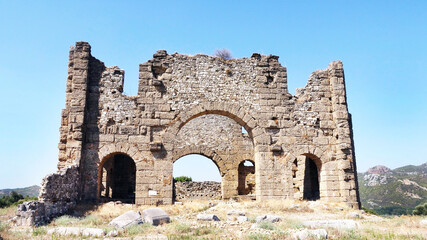 Wall Mural - Aqueduct and basilicas behind the historical Aspendos Ancient Theater in Antalya, Turkey