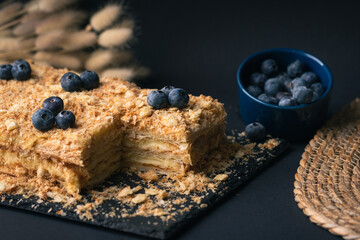 Wall Mural - Traditional homemade pastry Honey cake on the black background.