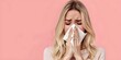 © Anastasiia - Unhealthy blonde woman blowing nose with tissues looking unwell due to allergies isolated on pink background. Concept Allergies, Unwell, Woman, Tissues, Isolated Background