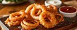Fried onion rings served on a plate,
