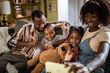 © Marko Geber - Happy African American family taking selfie at home with children