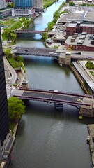 Wall Mural - Quick cars moving by the bridges over Chicago River. Big boat sailing by the river. Aerial perspective. Vertical video