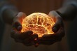 A conceptual image portraying hands holding a glowing brain illustrating ideas of intellect