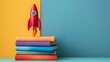 A red toy rocket lifting off from a stack of colorful books, igniting imagination