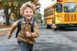 © Igor - small happy boy run in front of school bus