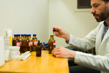 Wall Mural - Doctor doing the formula preparations for his homeopathic medicine